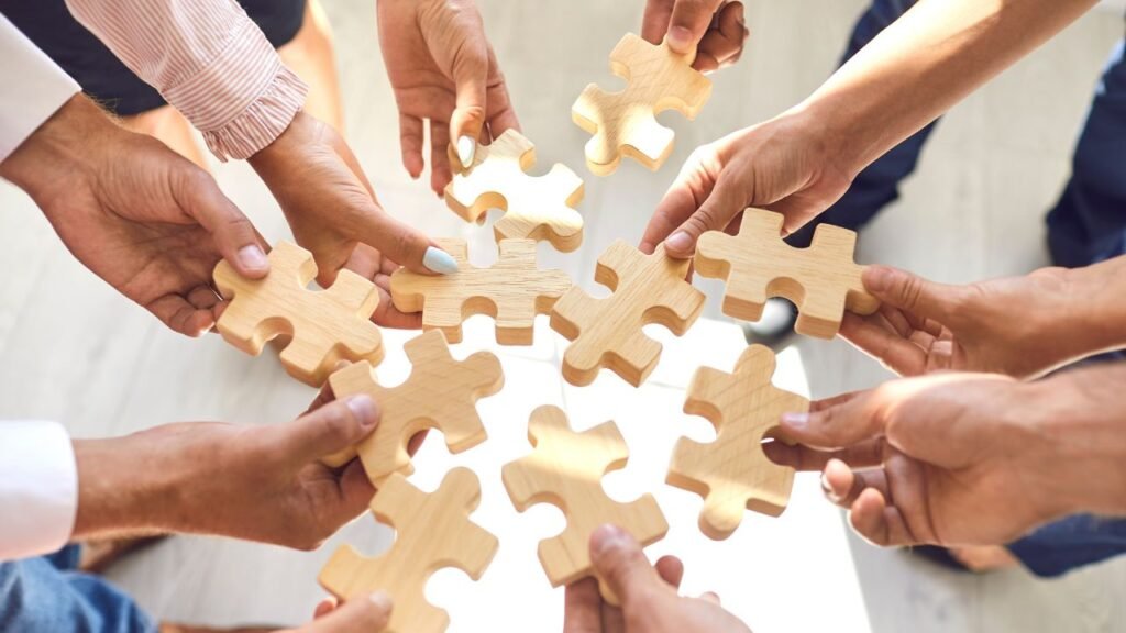 Company Employees Joining Pieces of Jigsaw Puzzle